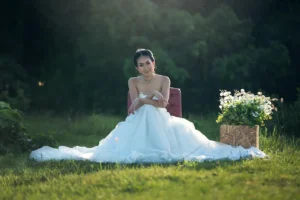 Bride in a white gown captured in a serene outdoor setting – About Tanmay Events wedding photography services.