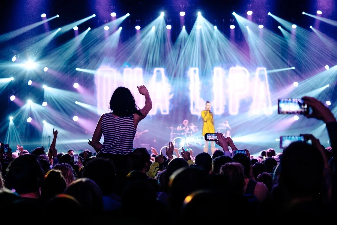A vibrant live stage performance with colorful lights and cheering crowd, flawlessly managed by Tanmay Events — Thrissur's leading event management company